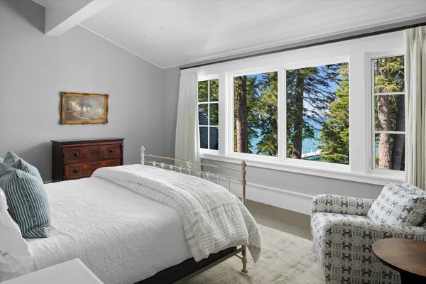 a bedroom with a bed and a large window