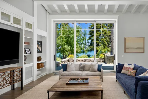 a living room with furniture windows and flat screen tv
