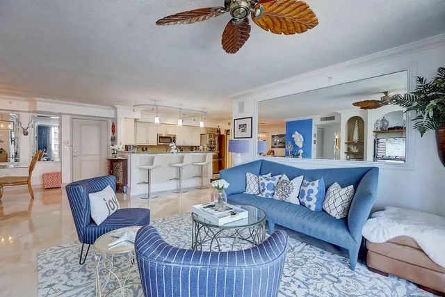 a view of a hallway with entryway wooden floor mirror and a chandelier