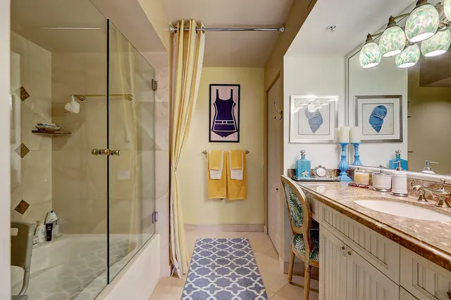 a bedroom with a bed and a dresser next to a window