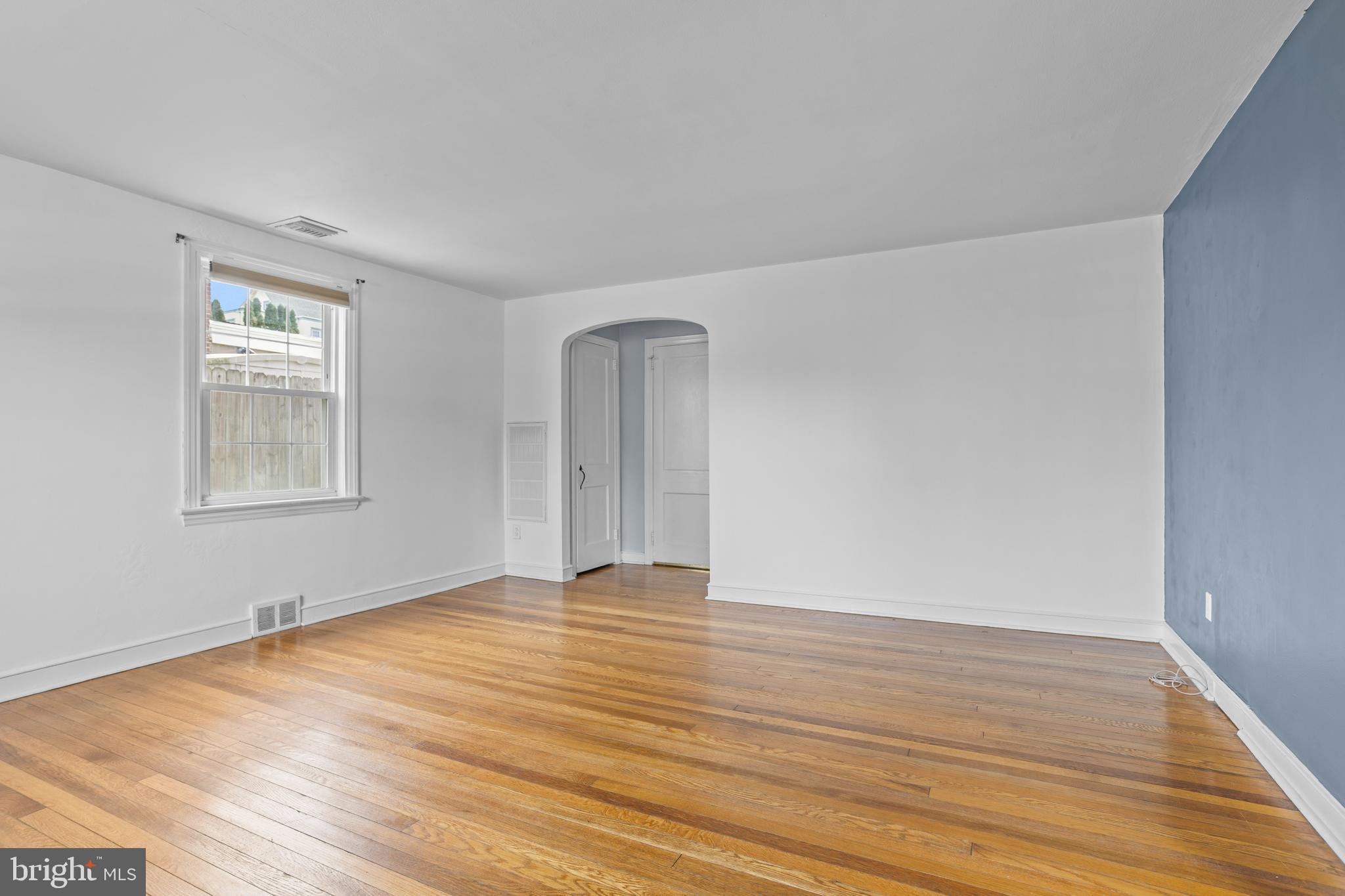 30 Wayne Avenue Springfield, PA 19064 - Photo 3 of 24 a view of an empty room with wooden floor and a window
