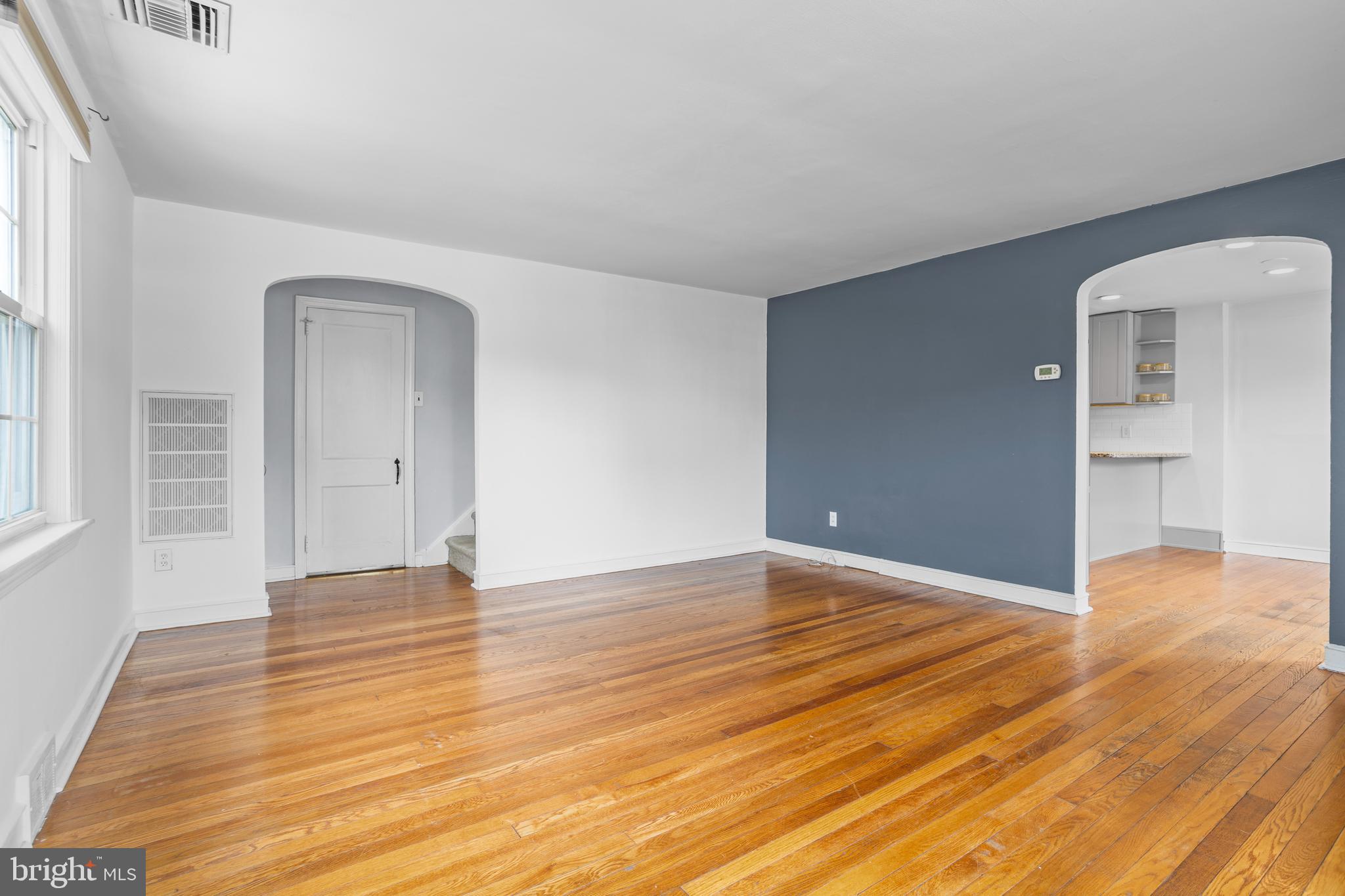 30 Wayne Avenue Springfield, PA 19064 - Photo 4 of 24 a view of an empty room with wooden floor and a window