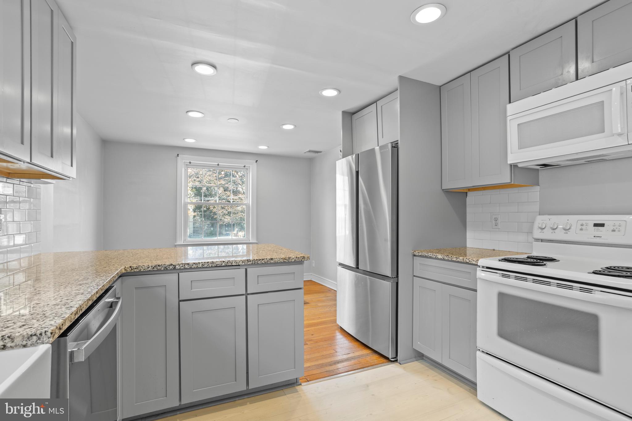 30 Wayne Avenue Springfield, PA 19064 - Photo 9 of 24 a kitchen with stainless steel appliances granite countertop a refrigerator and a stove top oven