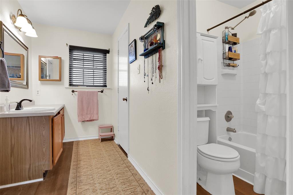 7634 Preston Road Denison, TX 75020 - Photo 13 of 34 a bathroom with a toilet sink and shower