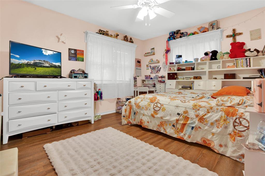 7634 Preston Road Denison, TX 75020 - Photo 17 of 34 a bedroom with a bed and a flat screen tv