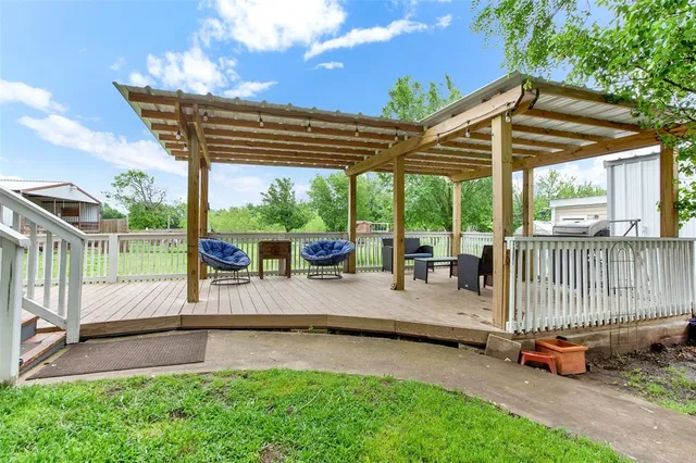a view of a patio with a table chairs and a backyard