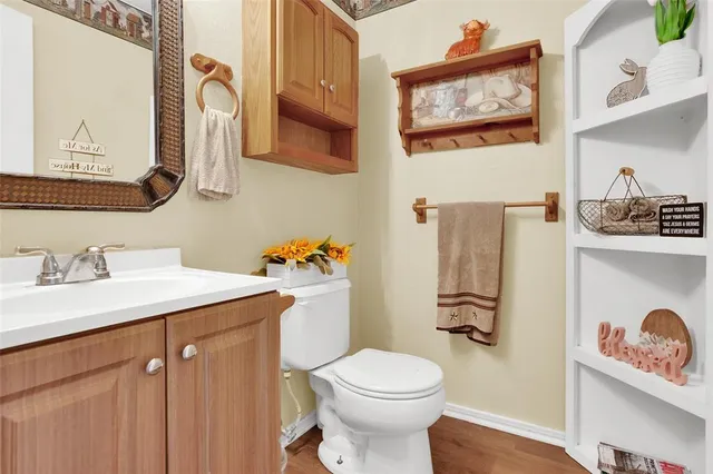 a bathroom with a sink vanity mirror and toilet