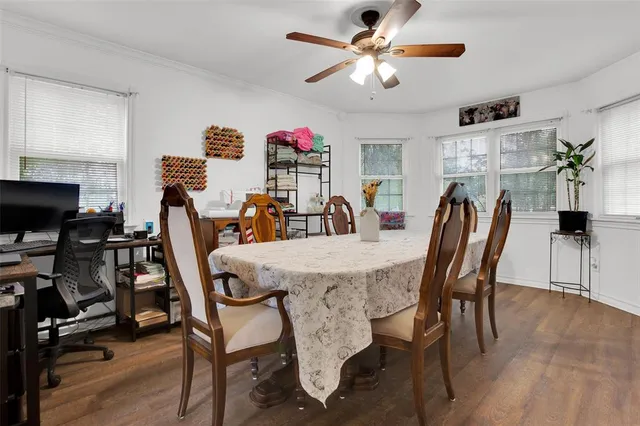 a view of a dining room with furniture and wooden floor