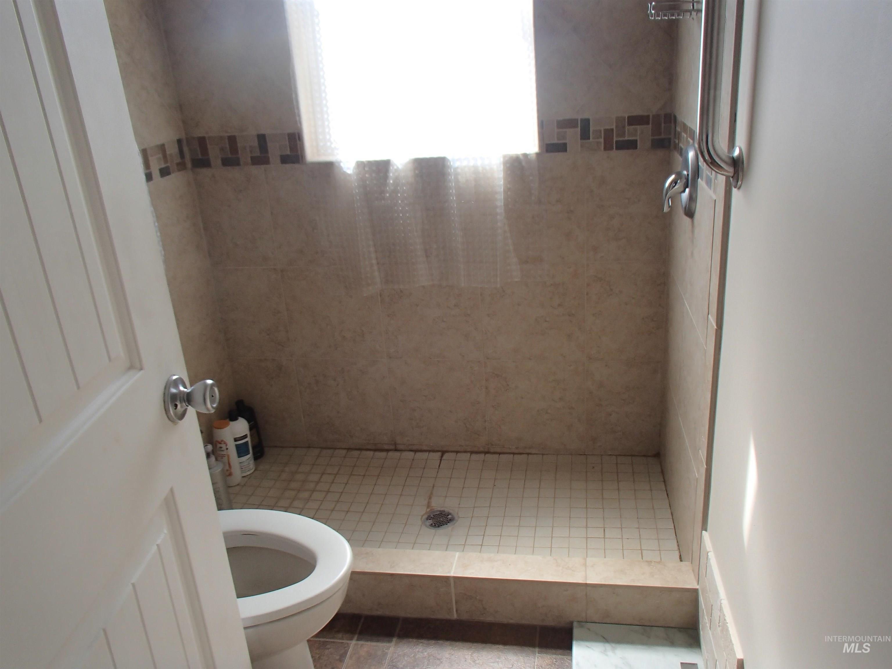 9506 Wright Road Melba, ID 83641 - Photo 11 of 37 Bathroom with a shower stall and toilet