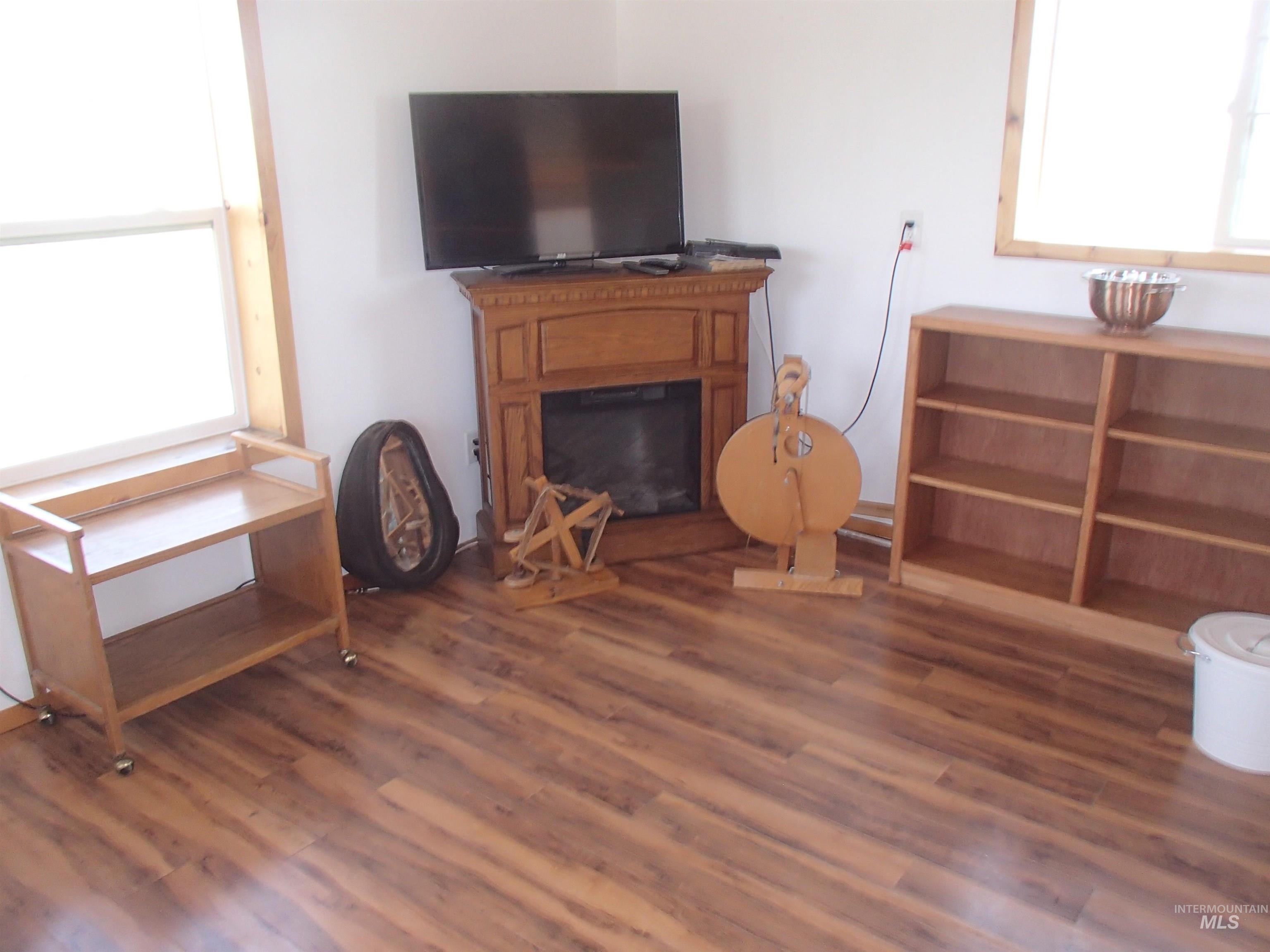 9506 Wright Road Melba, ID 83641 - Photo 4 of 37 Living area featuring dark wood finished floors and a glass covered fireplace