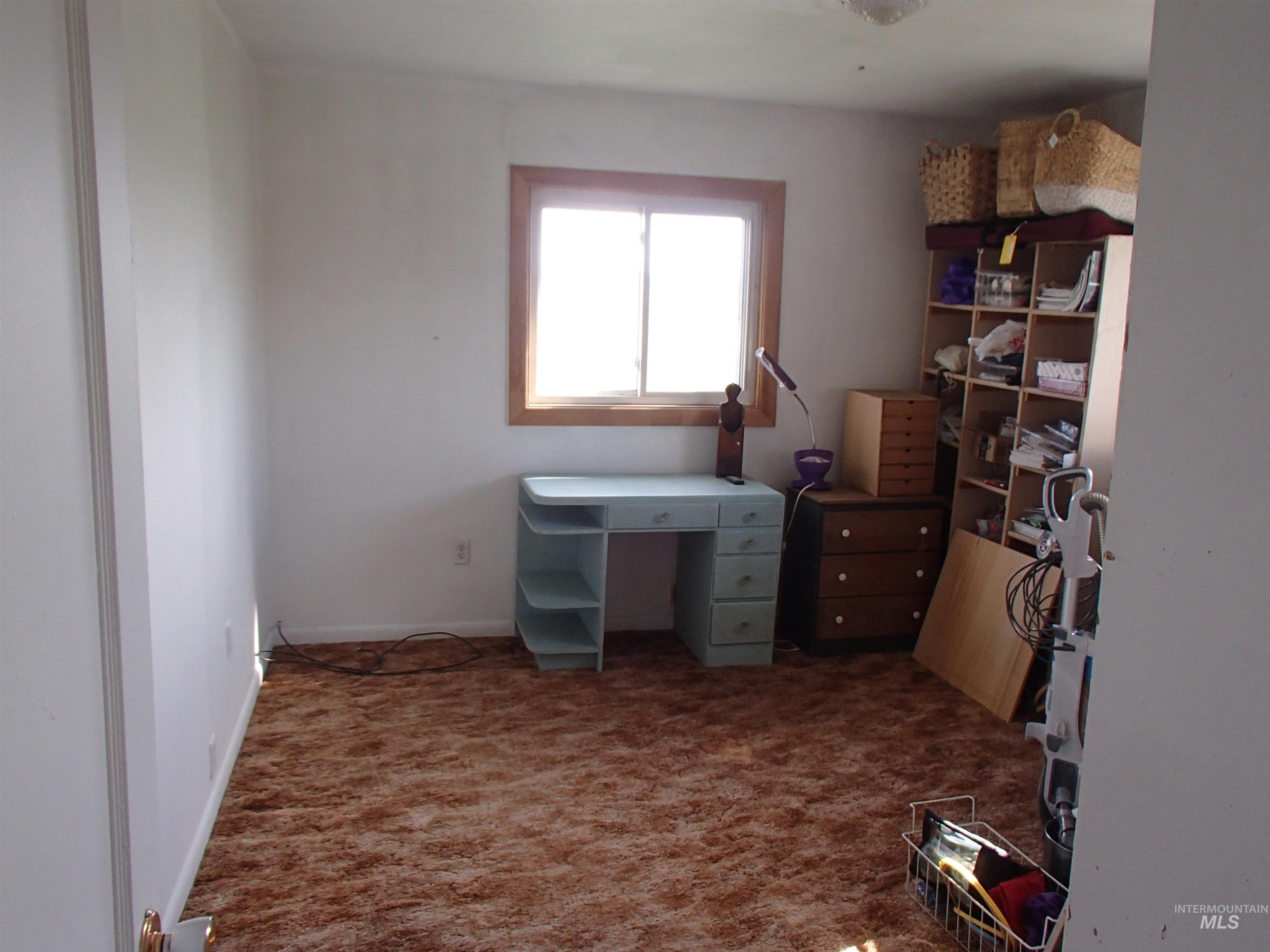 9506 Wright Road Melba, ID 83641 - Photo 10 of 37 bedroom space featuring dark carpet and baseboards