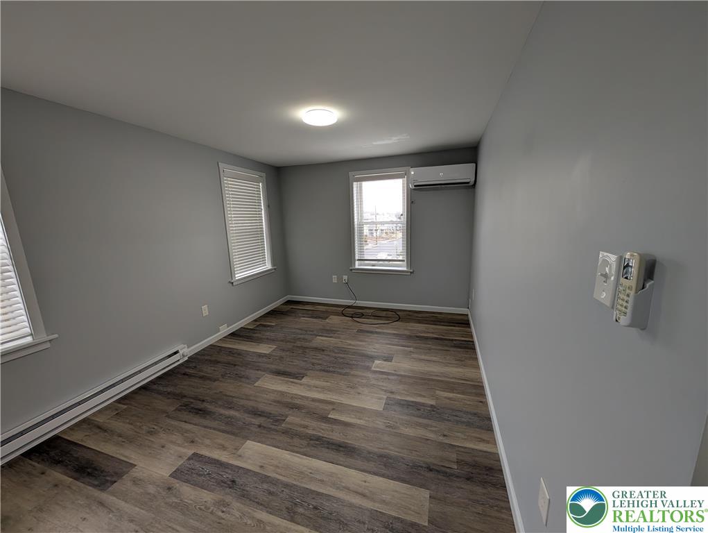 1111 Catasauqua Road, Unit 2 Whitehall, PA 18052 - Photo 3 of 9 an empty room with wooden floor and windows