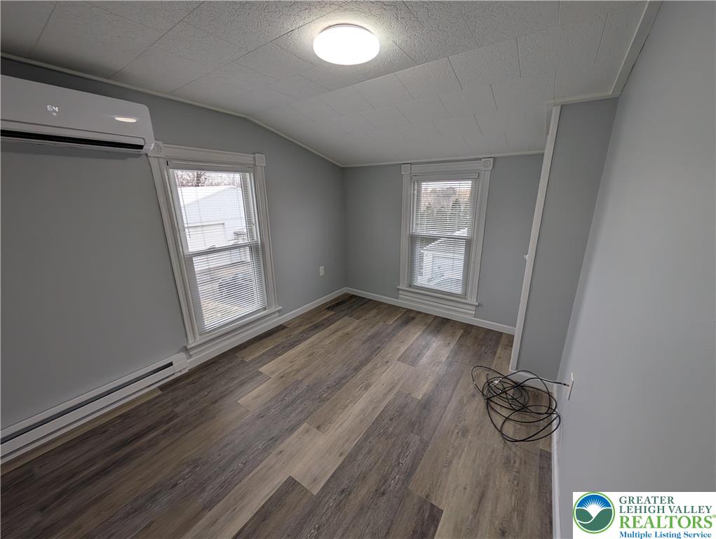 1111 Catasauqua Road, Unit 2 Whitehall, PA 18052 - Photo 8 of 9 an empty room with wooden floor and windows