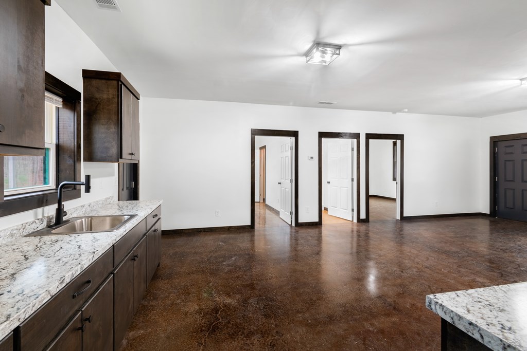 620 B Stiles Road Epworth, GA 30541 - Photo 11 of 20 a kitchen with granite countertop a sink and a refrigerator