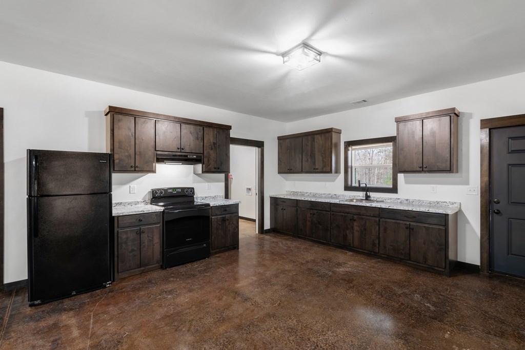 620 B Stiles Road Epworth, GA 30541 - Photo 3 of 20 a large kitchen with a refrigerator and a stove top oven