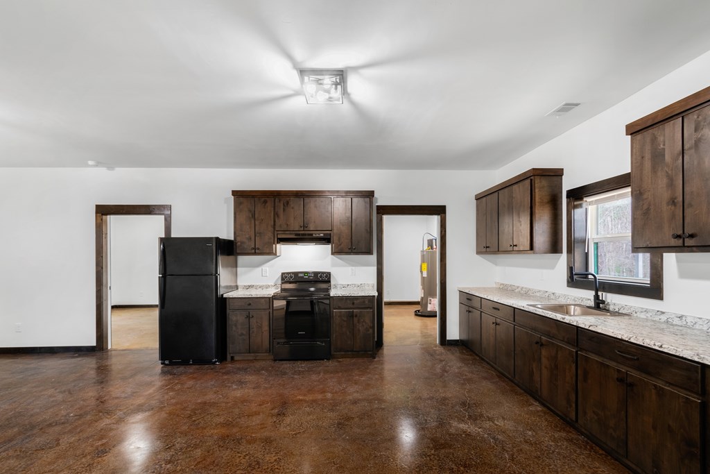 620 B Stiles Road Epworth, GA 30541 - Photo 5 of 20 a large kitchen with cabinets and stainless steel appliances