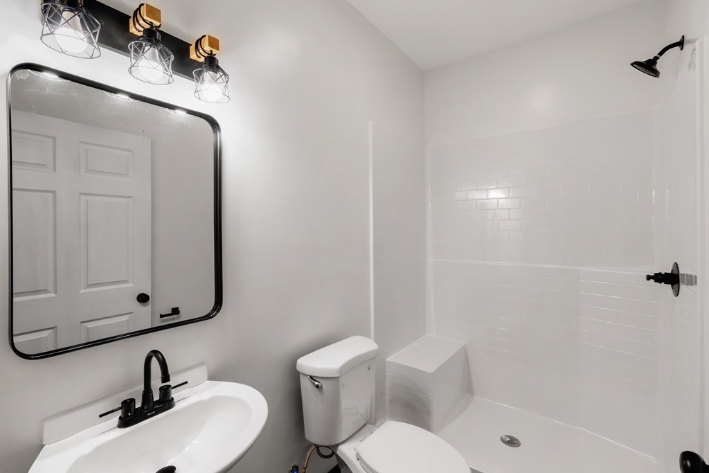 620 B Stiles Road Epworth, GA 30541 - Photo 6 of 20 a bathroom with a toilet sink and mirror