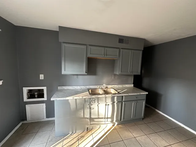 a kitchen that has a sink and a stove
