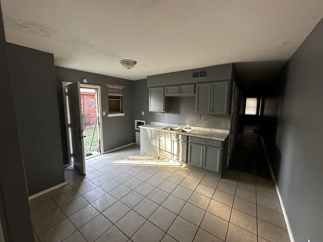 a kitchen with a stove top oven and cabinets