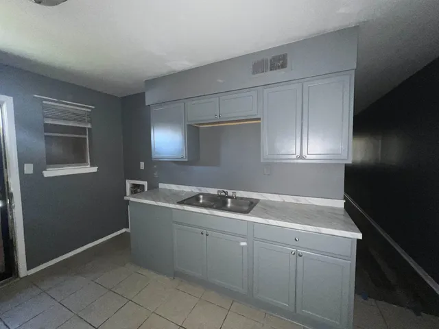a kitchen with a sink and cabinets