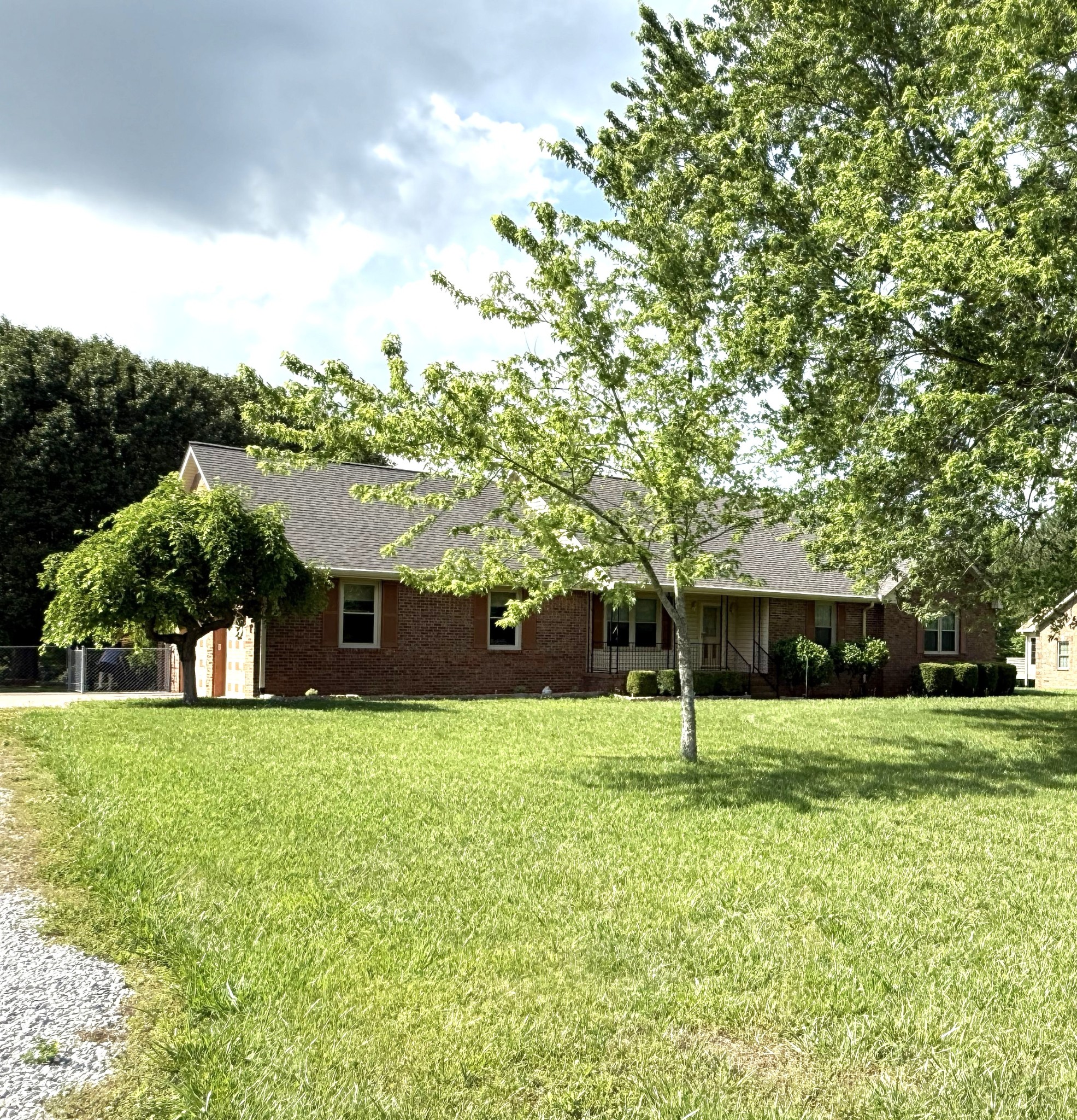 3168 Maxey Road Cedar Hill, TN 37032 - Photo 6 of 40 a view of a house with a big yard and large trees