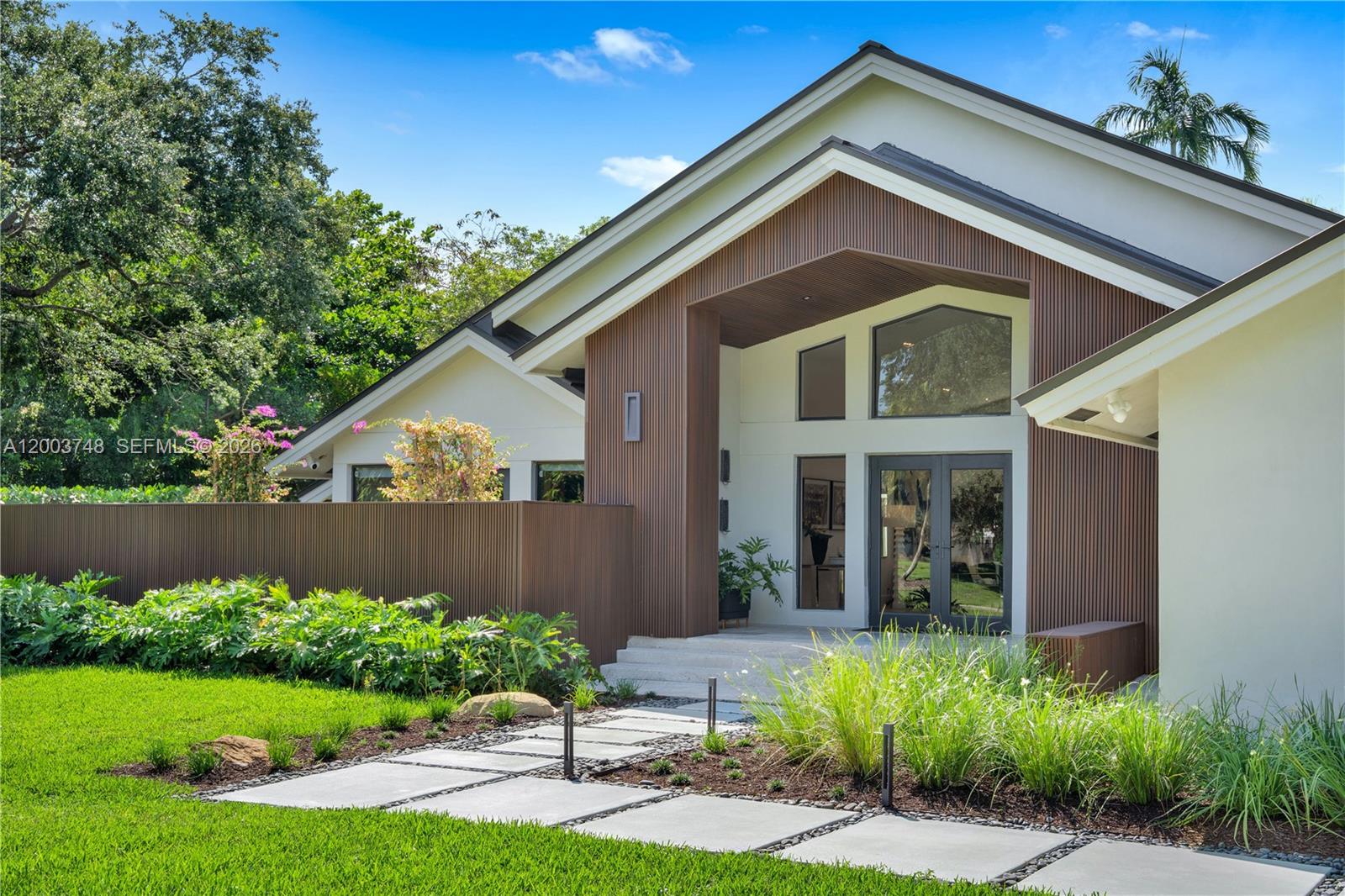 2675 Hackney Road Weston, FL 33331 - Photo 4 of 61 a front view of a house with a yard and potted plants