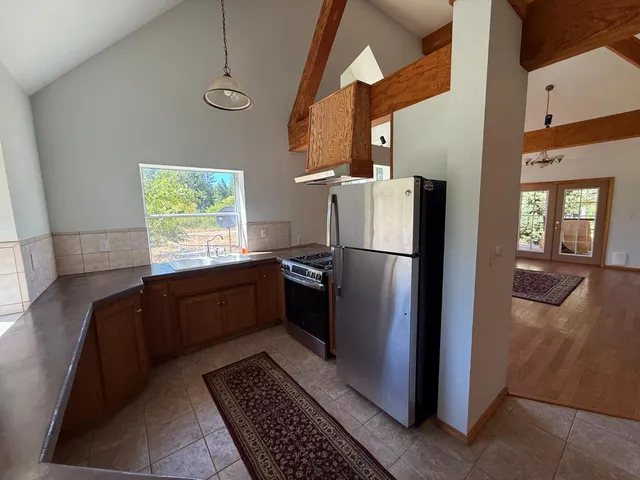 a kitchen with stainless steel appliances granite countertop a refrigerator and a sink