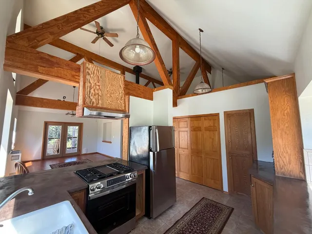 a kitchen with stainless steel appliances granite countertop a stove and a refrigerator