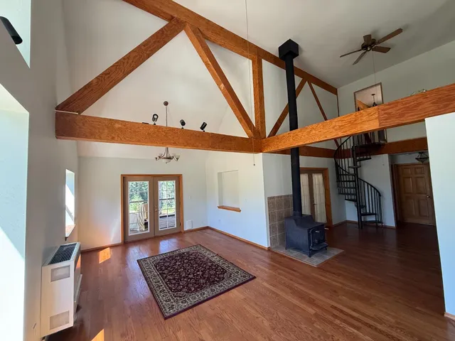 a living room with wooden floor and furniture