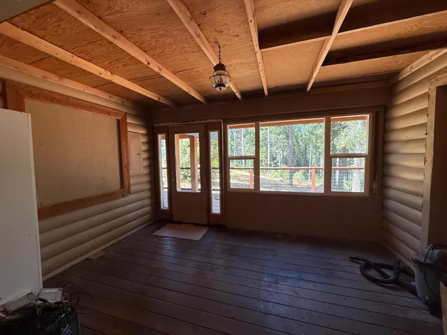 a view of room with wooden floor and windows