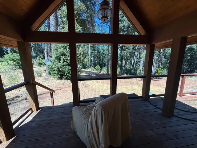 a living room with large windows and wooden floor