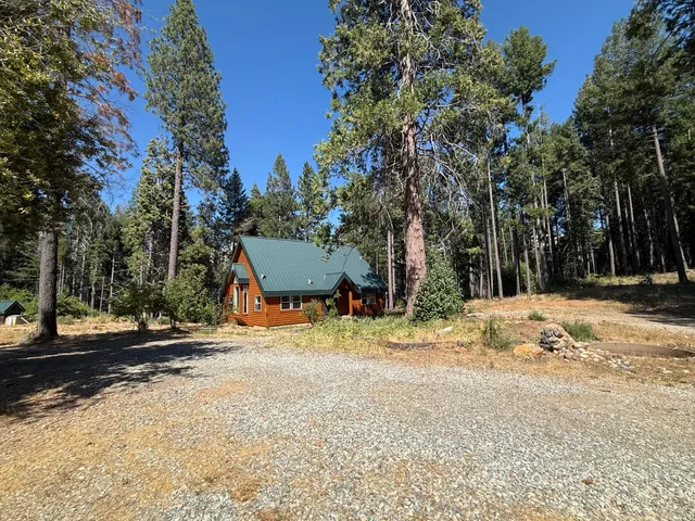 a view of a yard with snow on the road