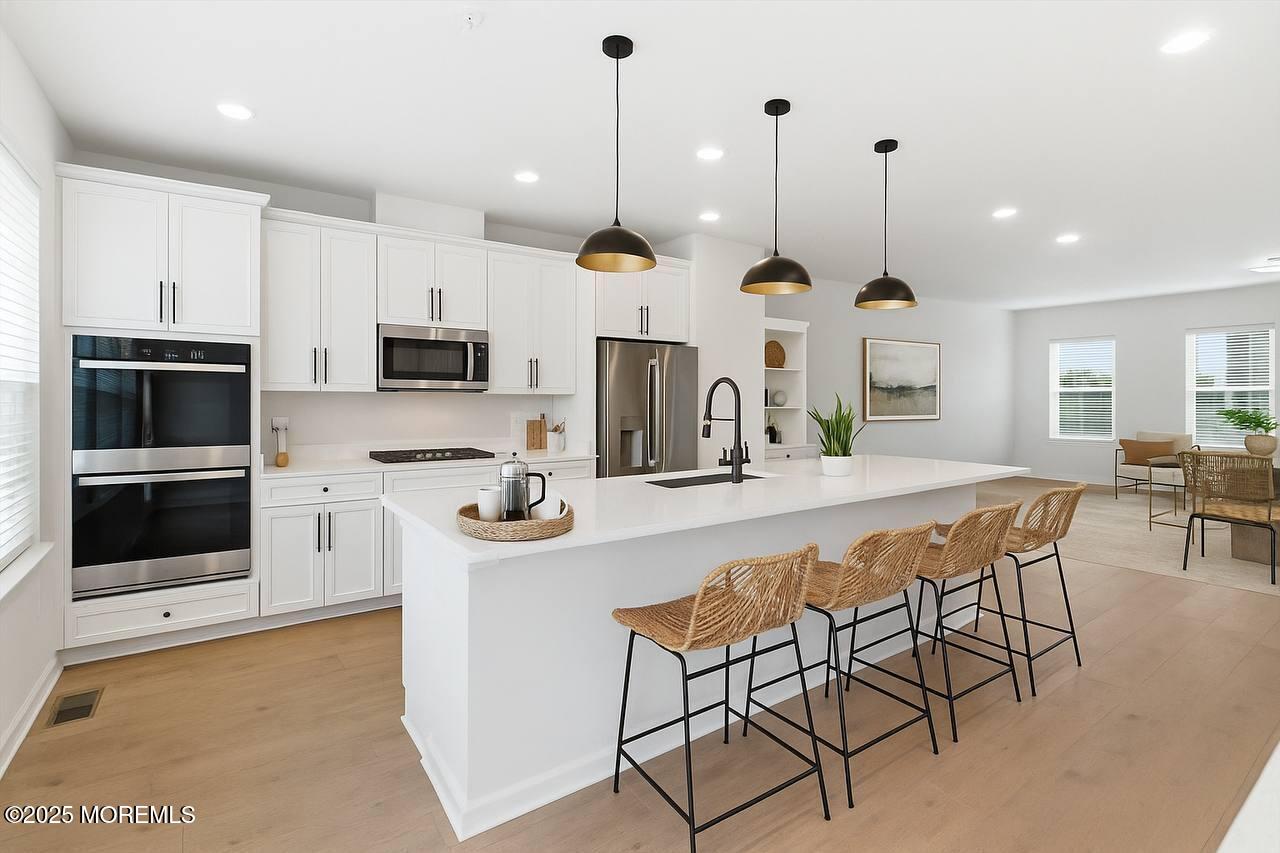 4 Barton Avenue Oceanport, NJ 07757 - Photo 15 of 47 a kitchen with stainless steel appliances kitchen island granite countertop a stove a sink and a microwave