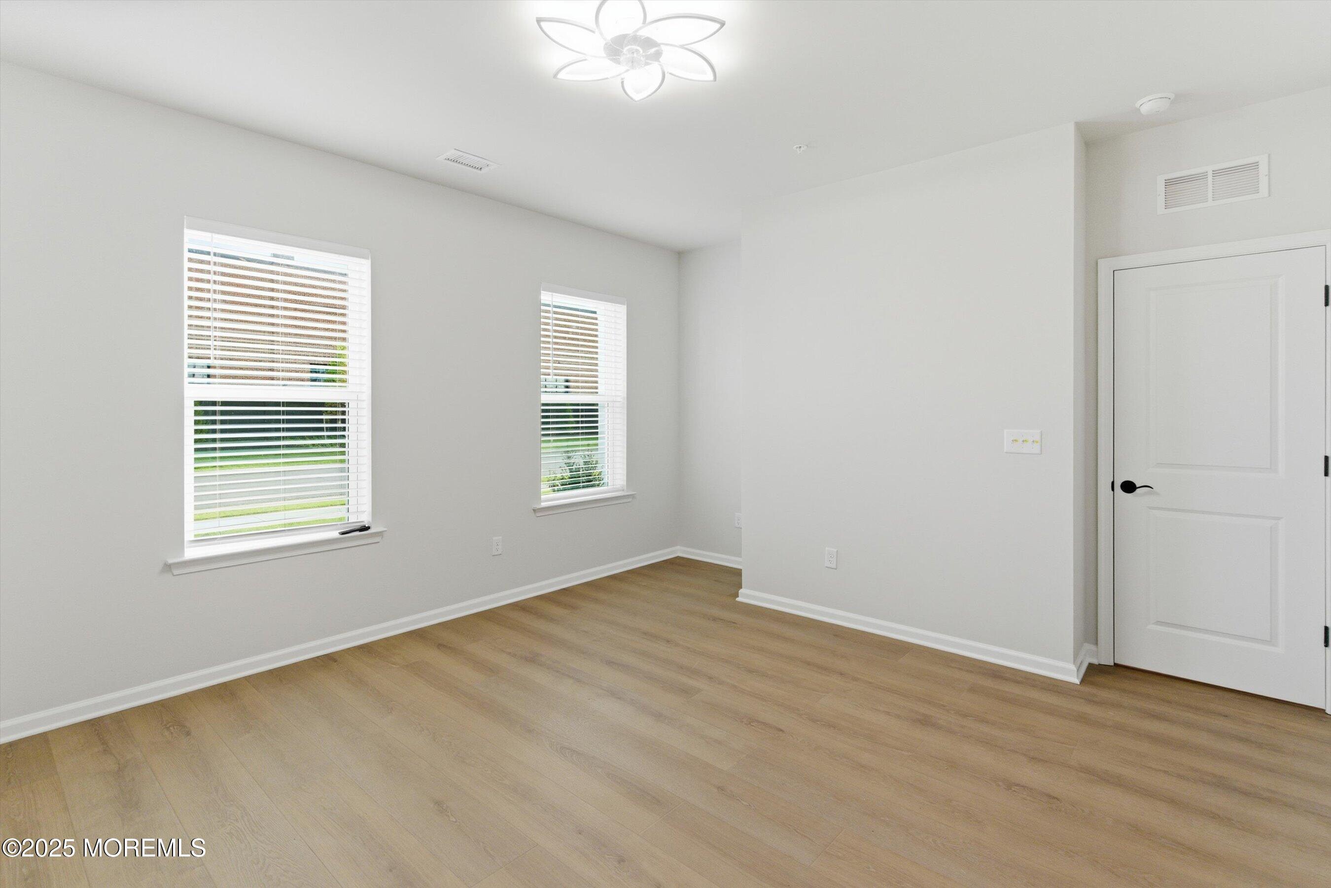 4 Barton Avenue Oceanport, NJ 07757 - Photo 7 of 47 an empty room with wooden floor and windows