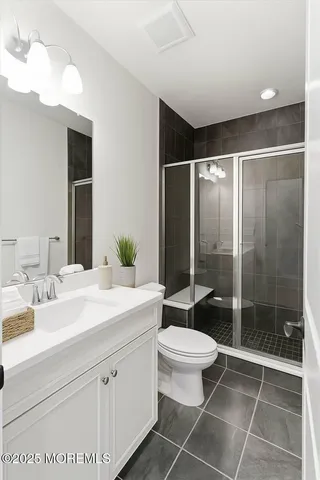 a bathroom with a sink a toilet and mirror