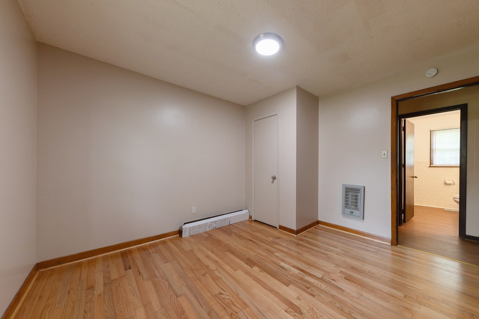1274 Fall River Road Goodspring, TN 38460 - Photo 12 of 24 a view of an empty room with wooden floor and a window