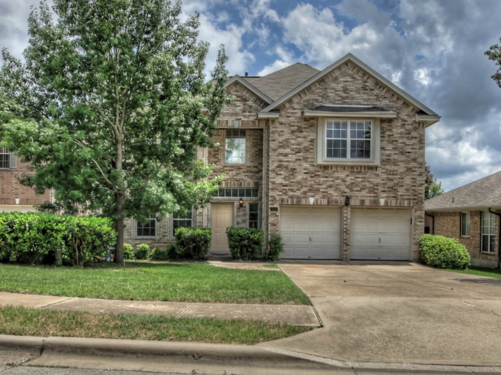 a front view of a house with a yard