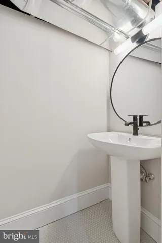 a bathroom with a sink and mirror