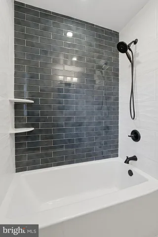 a bathroom with a bathtub and a shower