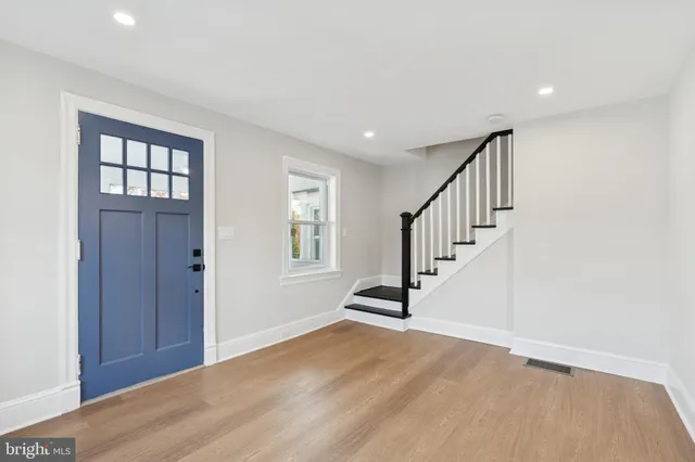 a view of entryway with wooden floor and stairs