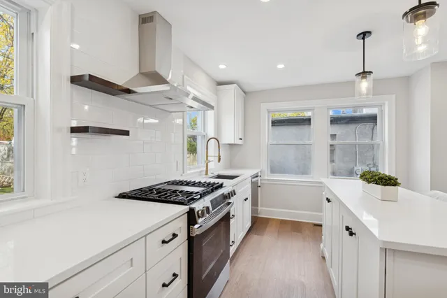 a kitchen with a sink stove and cabinets