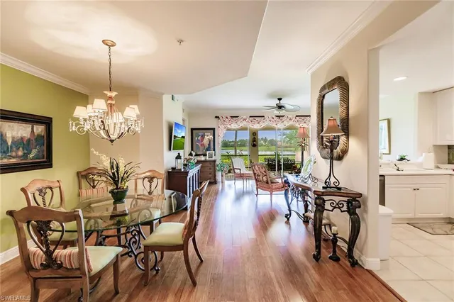 a view of a dining room with furniture wooden floor and chandelier