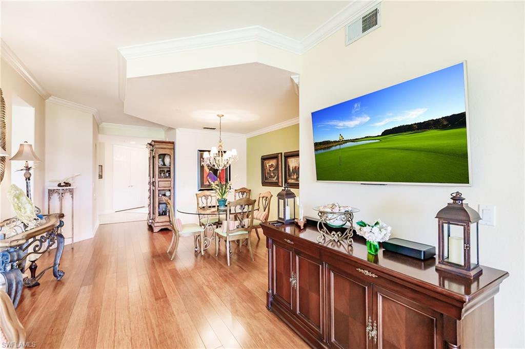3910 Deer Crossing Court, Unit 1 Naples, FL 34114 - Photo 14 of 38 a living room with furniture wooden floor and a flat screen tv