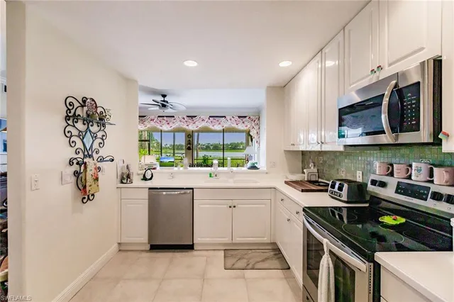 a kitchen with a sink a stove and cabinets