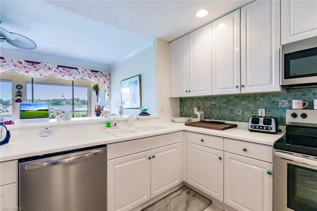 a kitchen with stainless steel appliances granite countertop a sink and cabinets