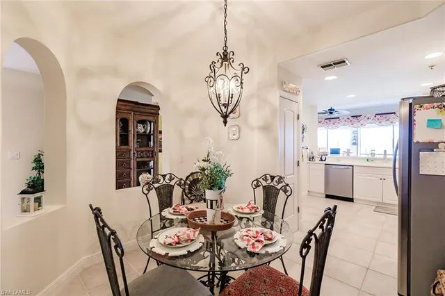a view of a dining room with furniture and a chandelier