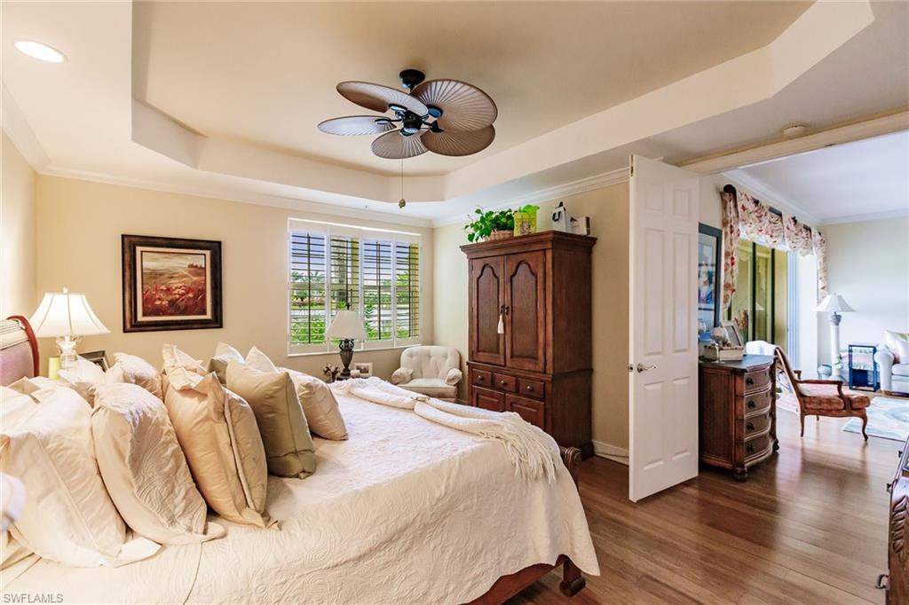 3910 Deer Crossing Court, Unit 1 Naples, FL 34114 - Photo 21 of 38 a bedroom with a bed and wooden floor