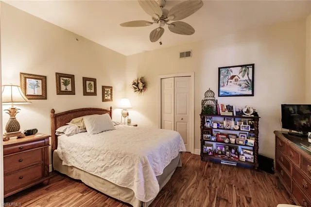 a bedroom with a bed and a tv on the dresser