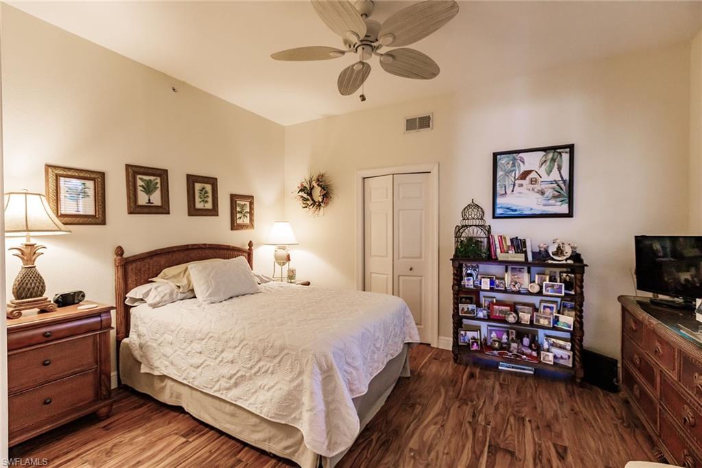 3910 Deer Crossing Court, Unit 1 Naples, FL 34114 - Photo 25 of 38 a bedroom with a bed and a tv on the dresser