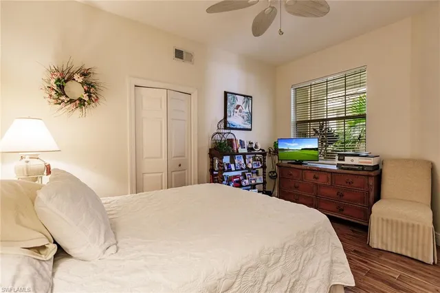 a bedroom with a bed dresser and a window
